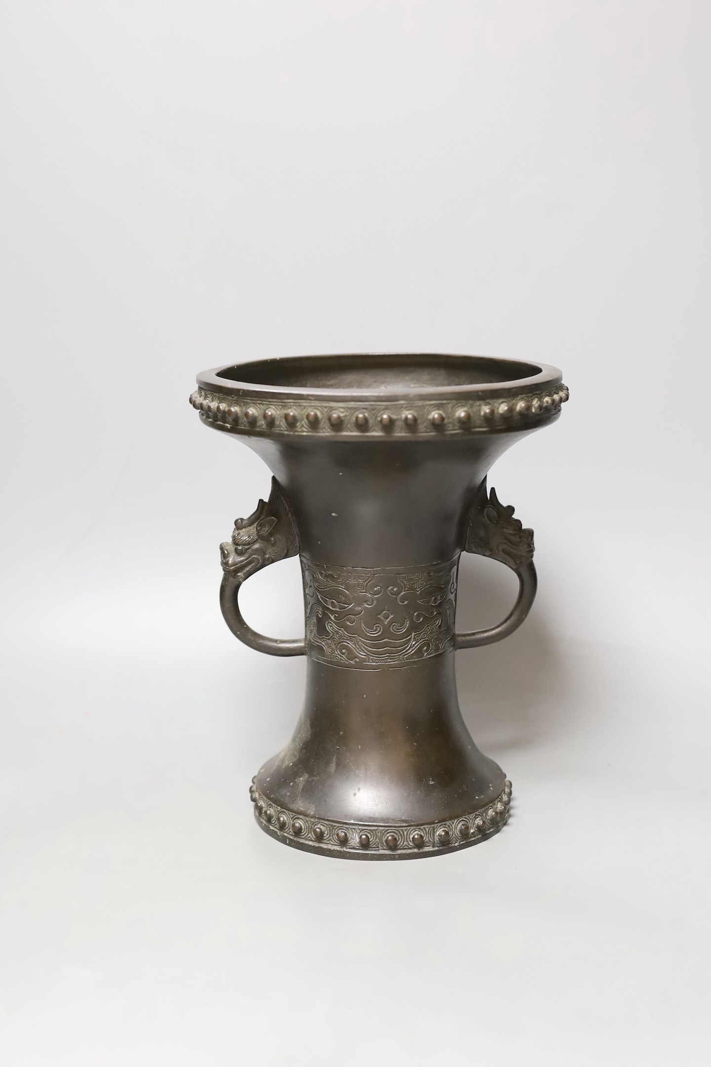 A Chinese or Japanese archaistic bronze two handle vase, 19th century, 24 cms high.